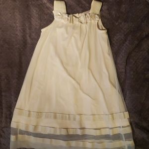 Cream girl's dress with flower and bow neckline